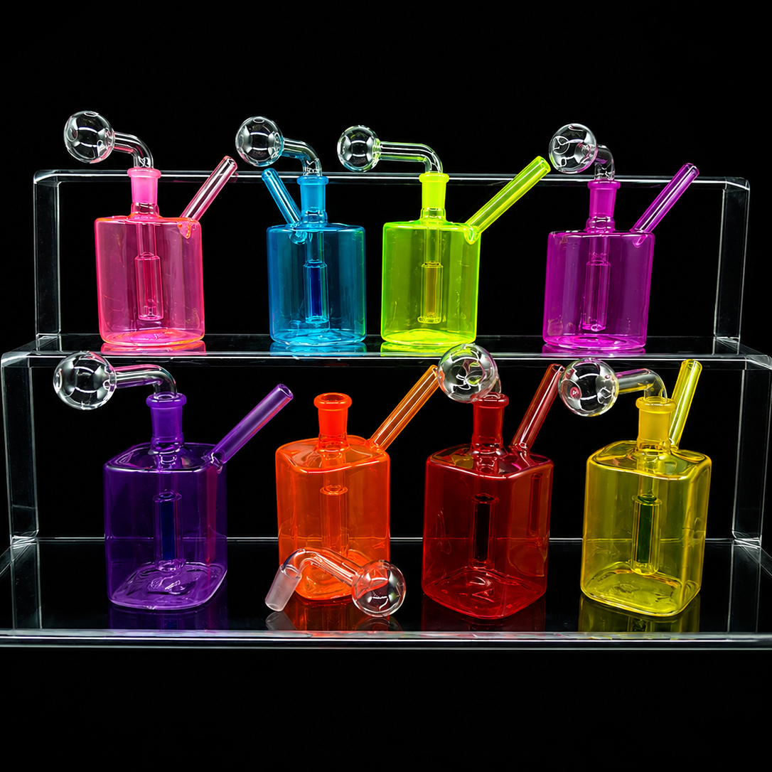 Six translucent glass water pipes in pink, blue, green, purple, orange, and red, arranged on a clear acrylic display stand against a black background.