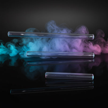 Three clear cylindrical objects on a light purple background