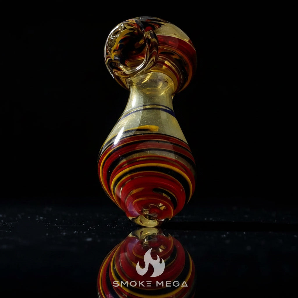 Glass hand pipe with golden teardrop swirl design, 5 inches, made of durable borosilicate glass.