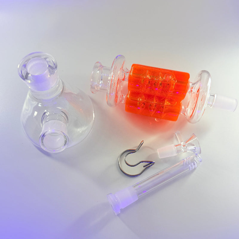 Fishing accessories including a clear bobber, orange plastic float, and fishing hook on a white background.