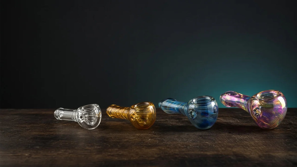 Four glass hand pipes from plain clear to color-changing art glass