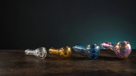 Four glass hand pipes from plain clear to color-changing art glass