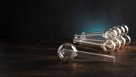 Single glass oil burner pipe in front of a bundle of oil burner pipes