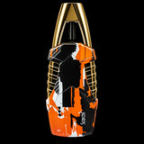 A handheld electric shaver with a metallic gold top handle and sides, featuring a black, orange, and white paint-splatter patterned body. The brand name 'Scaven' is printed vertically in white on the lower right of the body.