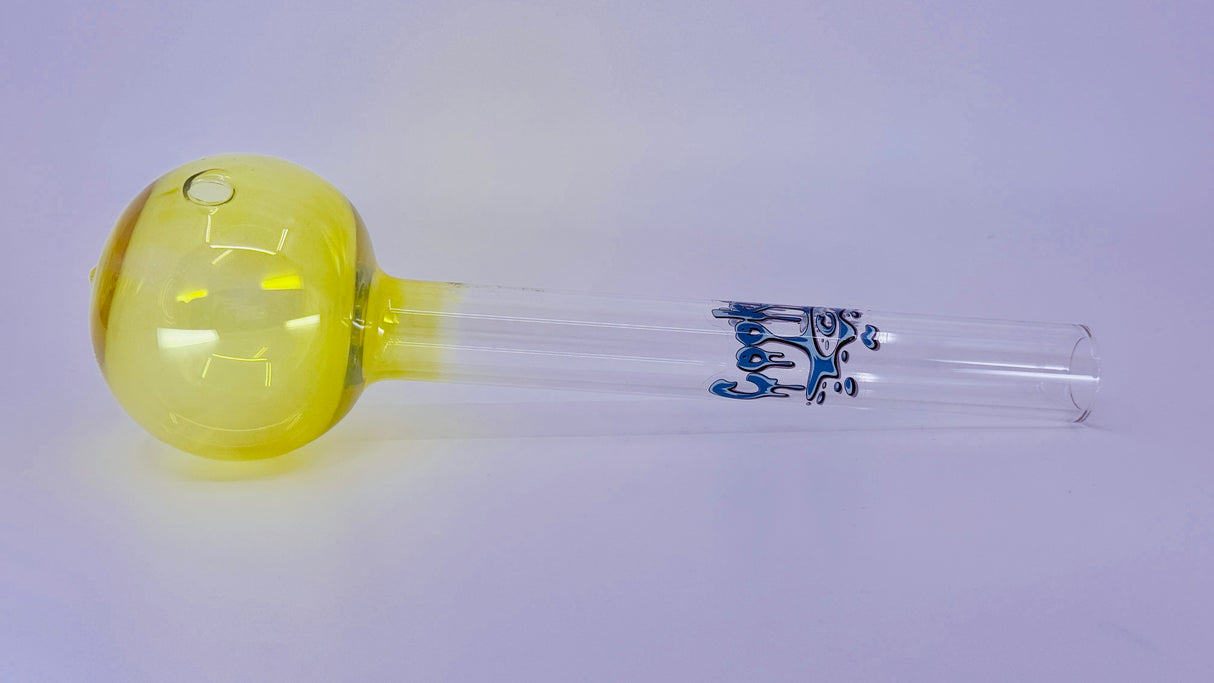 Yellow glass bulb with a clear tube and blue decorative element on a light purple background