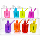 Nine colorful glass water pipes in pink, blue, yellow, purple, orange, red, and green, arranged on a clear acrylic display stand against a white background.