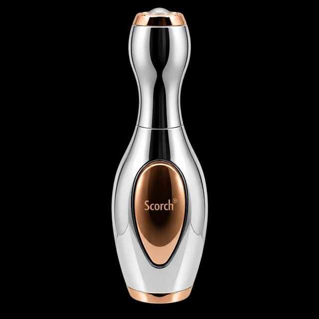 A handheld beauty device with a polished chrome silver body and rose gold accents, featuring the brand name 'Scorch' on a metallic oval panel on the front, set against a plain white background.