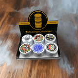 6 white cannabis grinders in a display box with assorted designs.