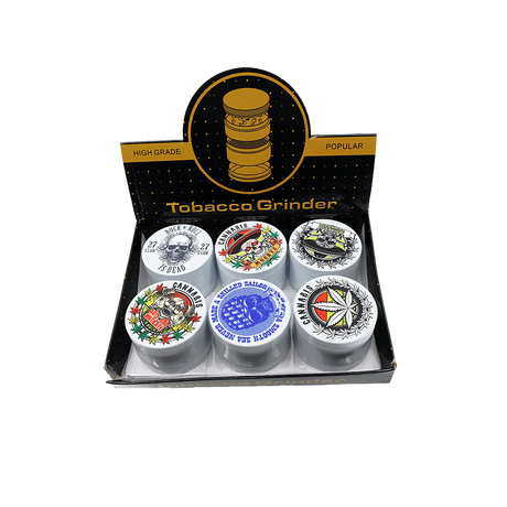 4 part heavy metal white cannabis grinder on display with various designs in packaging.