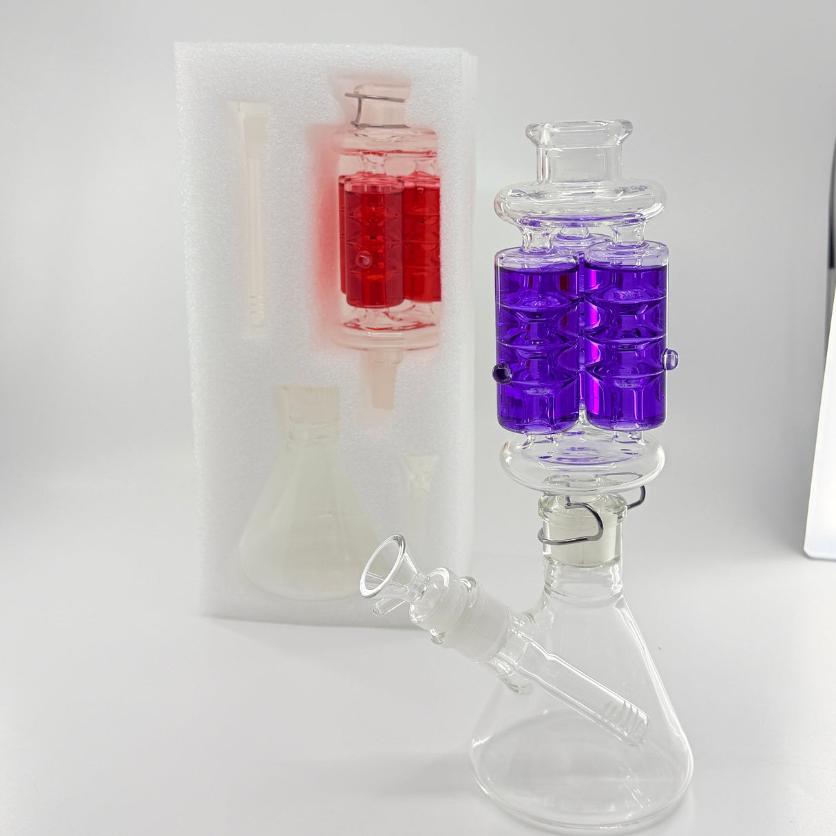 Glass beaker with purple liquid on a white background