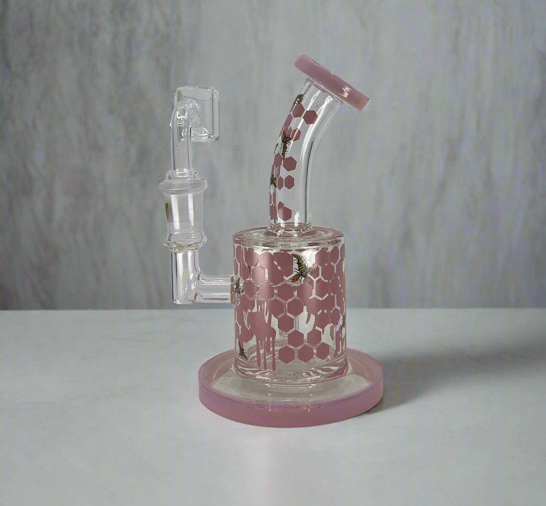 Honey bee dab rig with honeycomb design and pink accents.