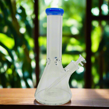Clear glass water pipe with a blue cap on a white background