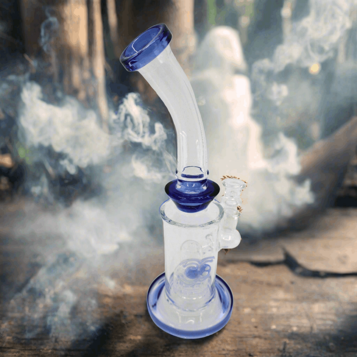 10-inch dab rig with blue accents and intricate glass artwork, featuring Showerhead Perc for smooth dabs, surrounded by smoke.