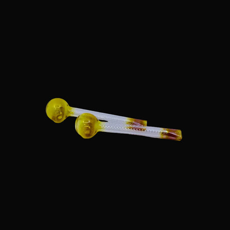 Two yellow glass vials with clear liquid on a light gray background