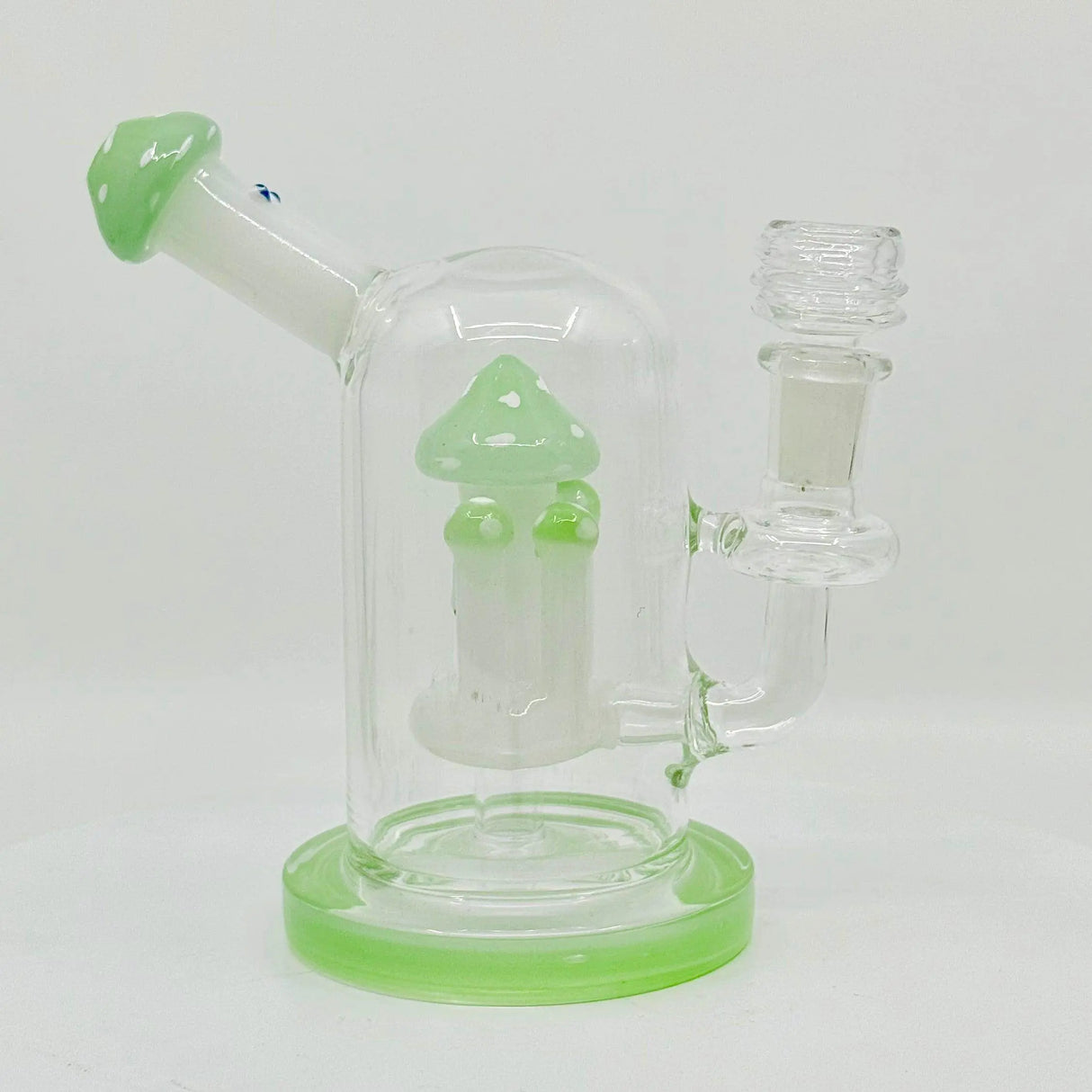 Fungi themed mushroom dab rig made of clear borosilicate glass with green accents for smooth filtration.