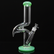 Glass smoking device with green base and accents on a white background