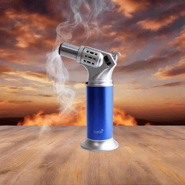 Scorch Torch Lighter - 7 against a fiery sunset background on a wooden surface.