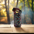 Sorch Torch -11 torch lighter with ergonomic design on wooden table in forest setting.