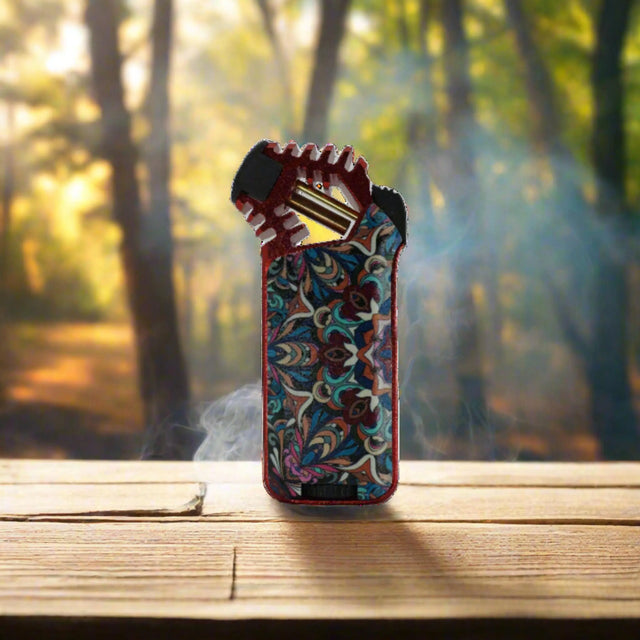 Sorch Torch -11 torch lighter with ergonomic design on wooden table in forest setting.